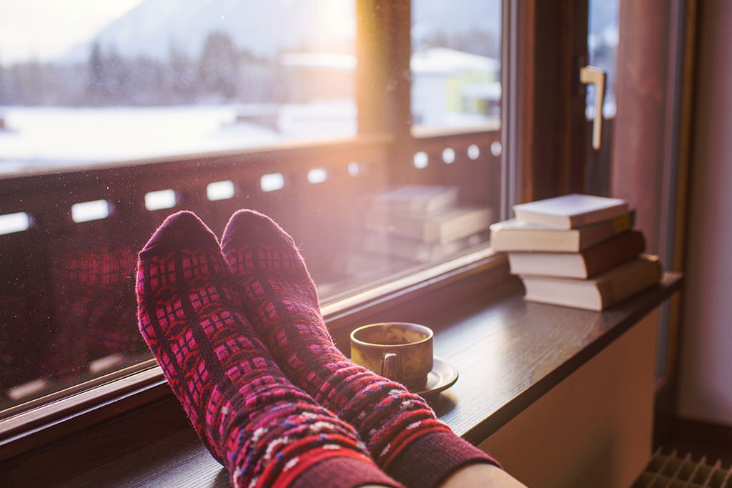 woman with cozy socks and feet up resting