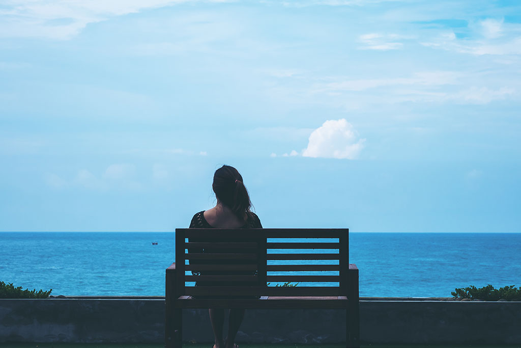 woman sitting on a bench sitting on a bench alone feeling lonely