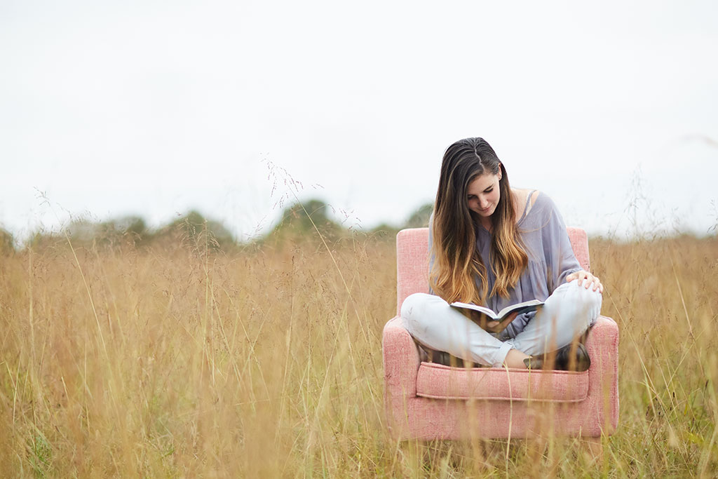 Woman having a Quiet Time reading Bible out in nature