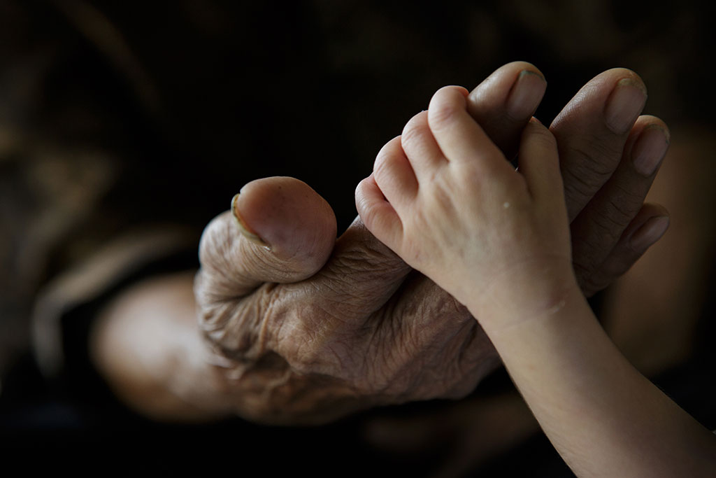 Baby's hand in an old person's hand