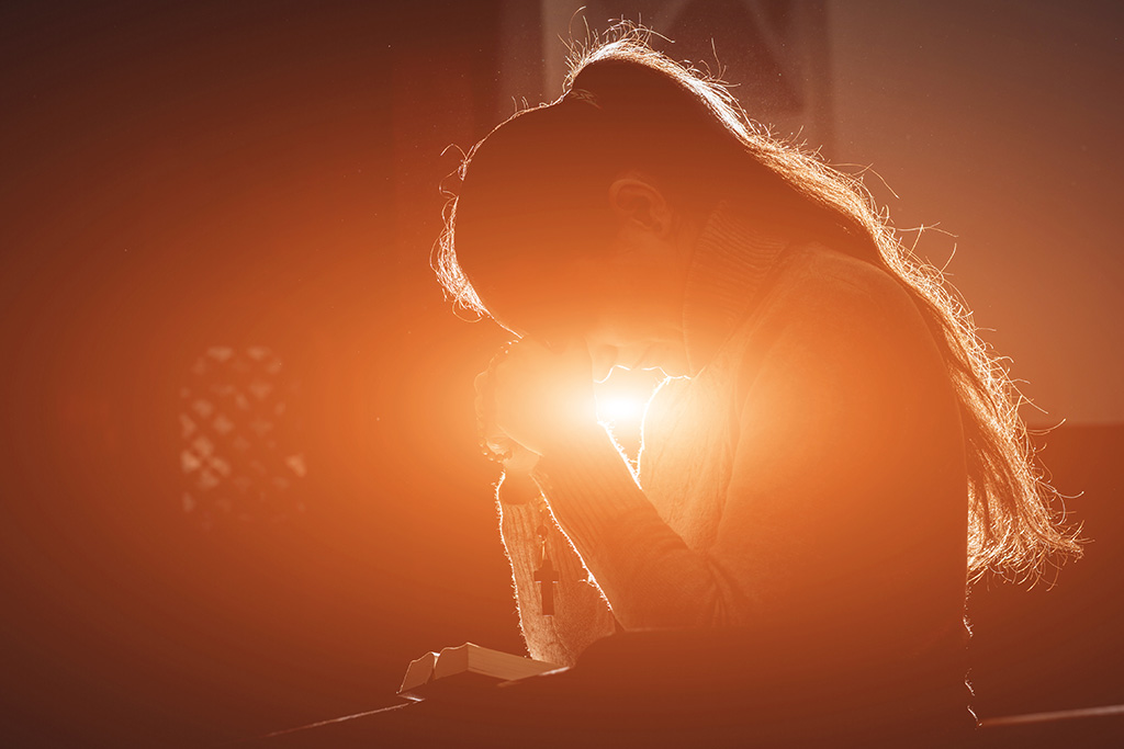 Woman with light coming through from the church window