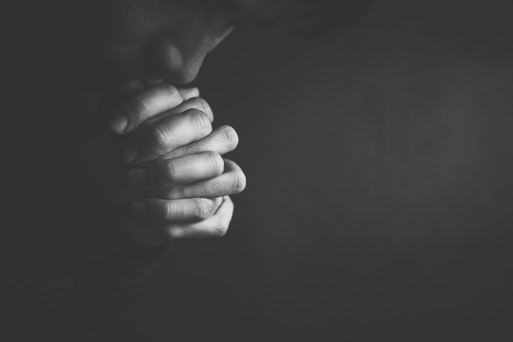 Man praying in the dark