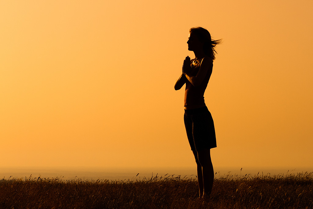 Woman praying out of gratitude to God