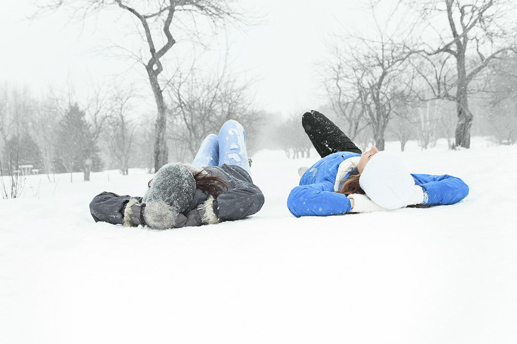 Teens lying in the snow talking