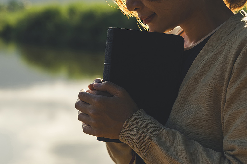 Person having a daily devotional time reading their Bible and praying