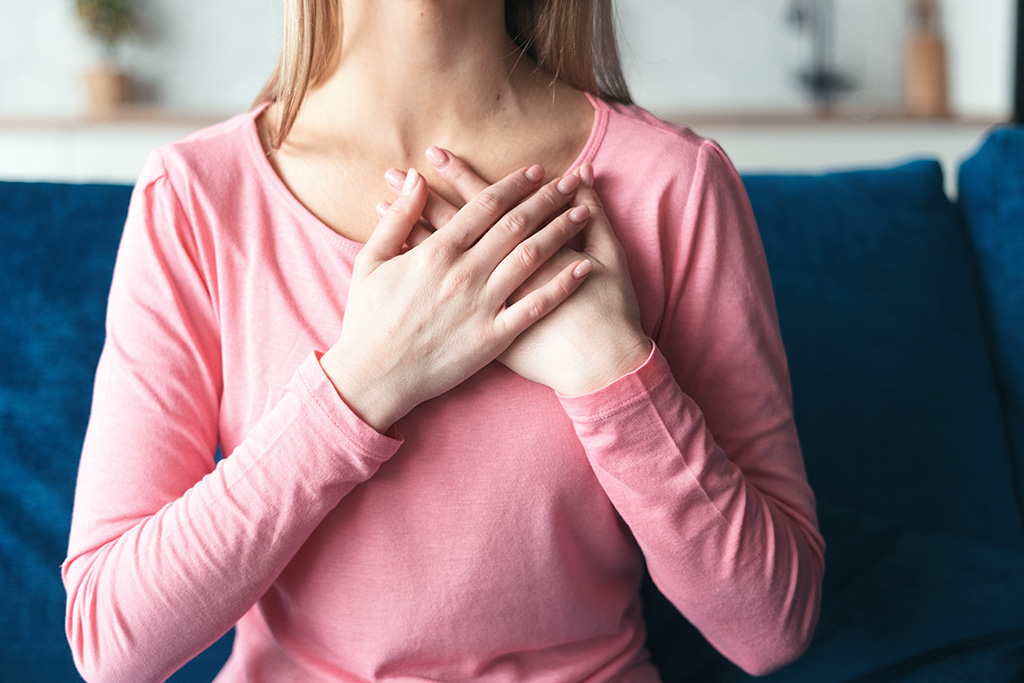 Woman with hand over heart symbolizing cherishing God's faithfulness