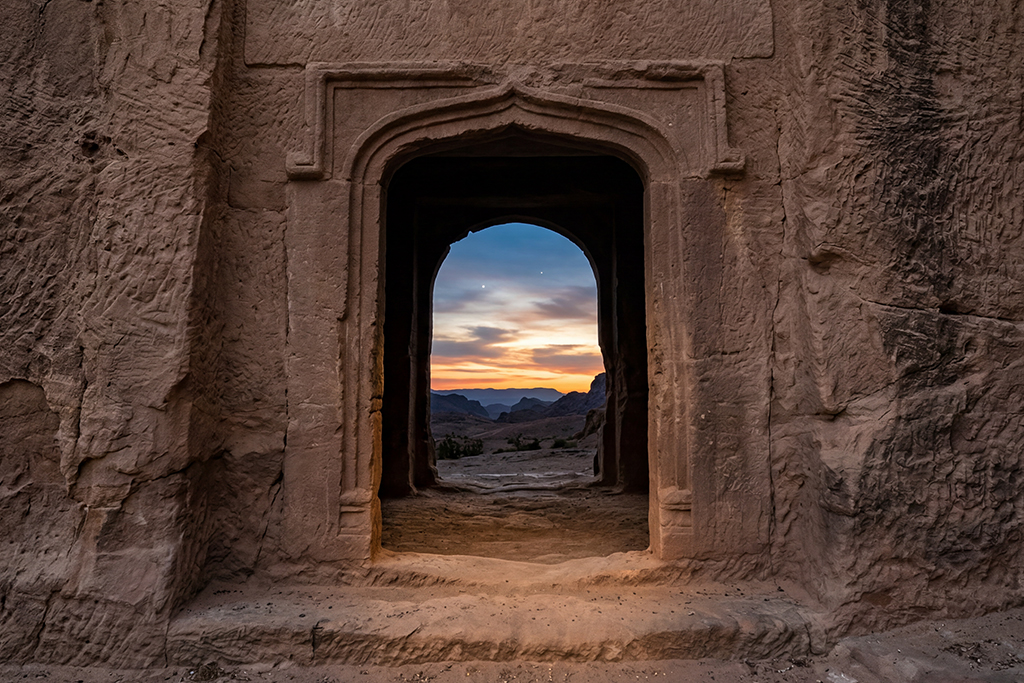 Photo of ancient building and scenery through a doorway
